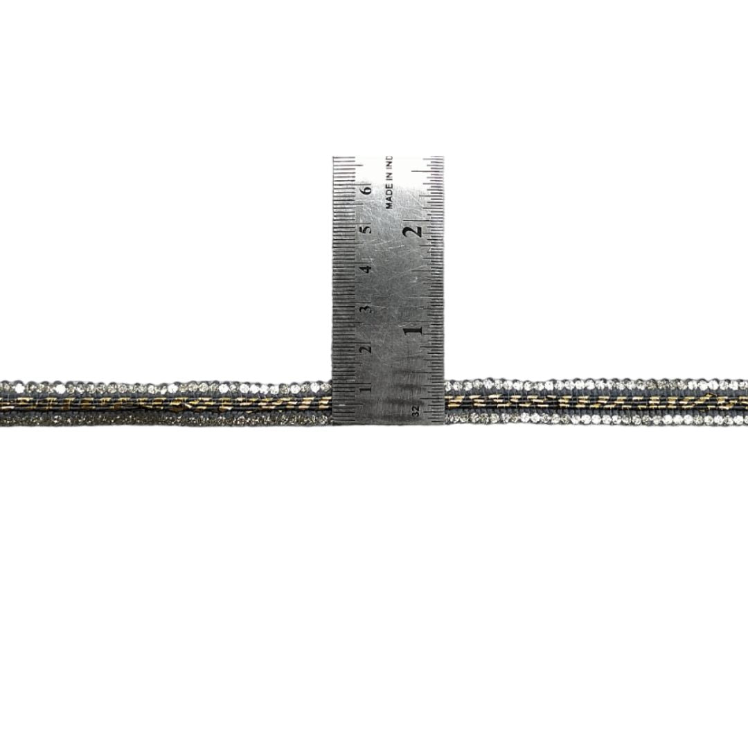 Metallic beaded strip with a ruler for scale on a white background